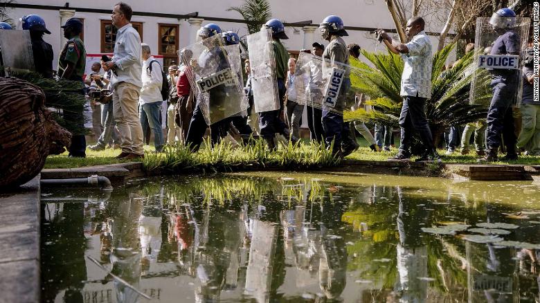 Zimbabwe anti-riot police personnel deploy Friday at the Bronte Hotel in Harare.