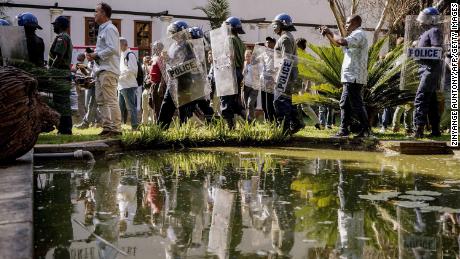 Zimbabwe anti-riot police personnel deploy Friday at the Bronte Hotel in Harare.