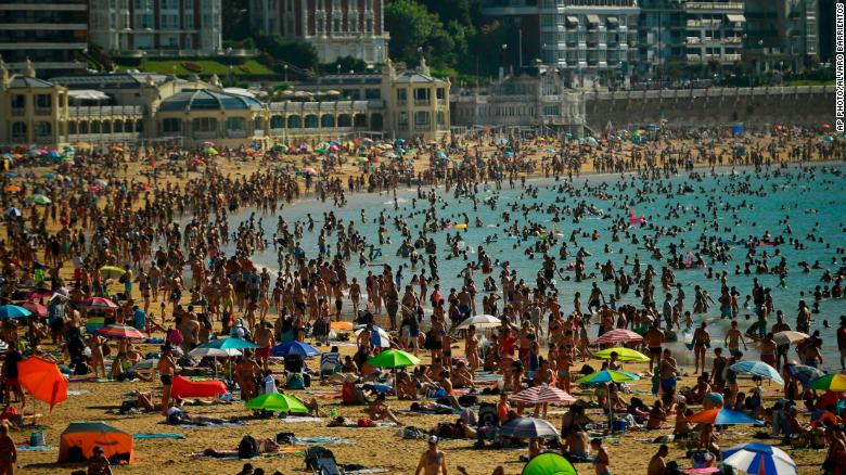 People crowd La Concha beach Friday in the Basque city of San Sebastian in northern Spain.