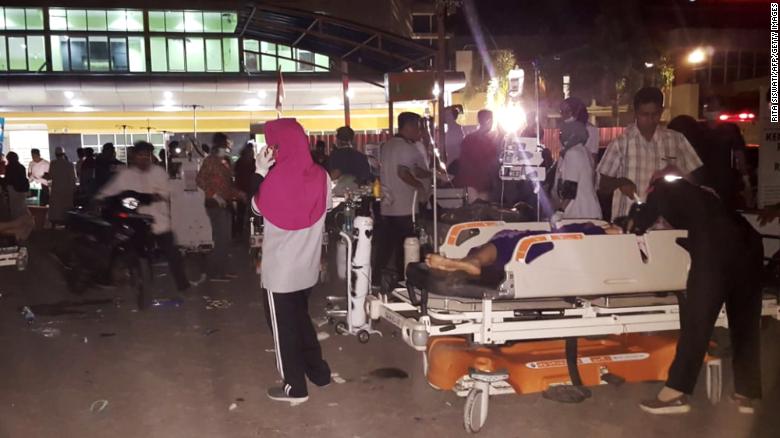 Medical staff treat patients outside a hospital on Lombok Island after an earthquake rocked Indonesia on Sunday.