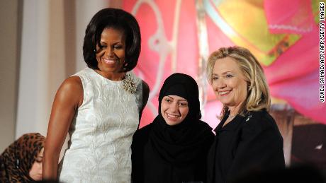 Former US First Lady Michelle Obama and Former Secretary of State Hillary Clinton pose with Samar Badawi of Saudi Arabia as she receives the 2012 International Women of Courage Award during a ceremony at the US State Department.