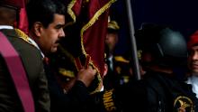 Venezuelan President Nicolas Maduro (L) attends a ceremony to celebrate the 81st anniversary of the National Guard in Caracas on August 4, 2018. - Maduro was unharmed after an exploding drone "attack", the minister of communication Jorge Rodriguez said following the incident, which saw uniformed military members break ranks and scatter after a loud bang interrupted the leader's remarks and caused him to look to the sky, according to images broadcast on state television. (Photo by Juan BARRETO / AFP)        (Photo credit should read JUAN BARRETO/AFP/Getty Images)