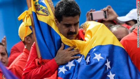 TOPSHOT - Venezuelan President Nicolas Maduro holds a national flag during the closing of the campaign to elect a Constituent Assembly that would rewrite the constitution, in Caracas on July 27, 2017 on the second day of a 48-hour general strike called by the opposition.
Venezuela&#39;s opposition called for a nationwide protest on Friday in outright defiance of a new government ban on demonstrations ahead of a controversial weekend election. &quot;The regime declared we can&#39;t demonstrate... We will respond with the TAKING OF VENEZUELA tomorrow,&quot; the opposition coalition, the Democratic Unity Roundtable, said Thursday on its Twitter account.
 / AFP PHOTO / Federico PARRA        (Photo credit should read FEDERICO PARRA/AFP/Getty Images)