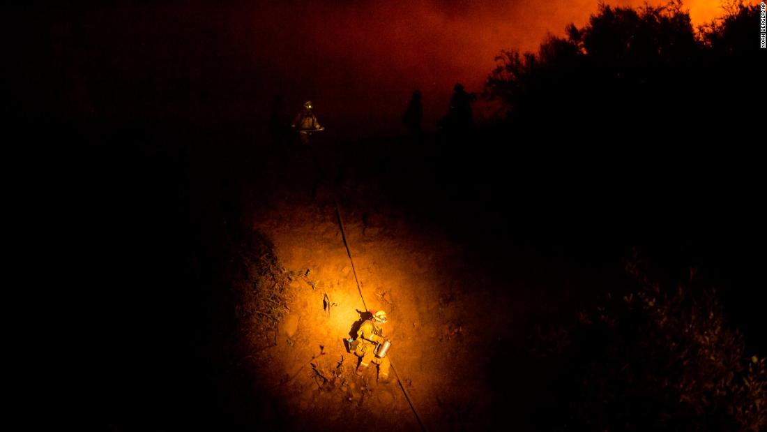 A firefighter makes his way down a hillside while battling the Mendocino Complex Fire on August 7.