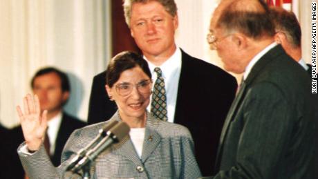 Chief Justice of the U.S. Supreme Court William Rehnquist (R) administers the oath of office to newly-appointed U.S. Supreme Court Justice Ruth Bader Ginsburg (L) as U.S. President Bill Clinton looks on 10 August 1993. 