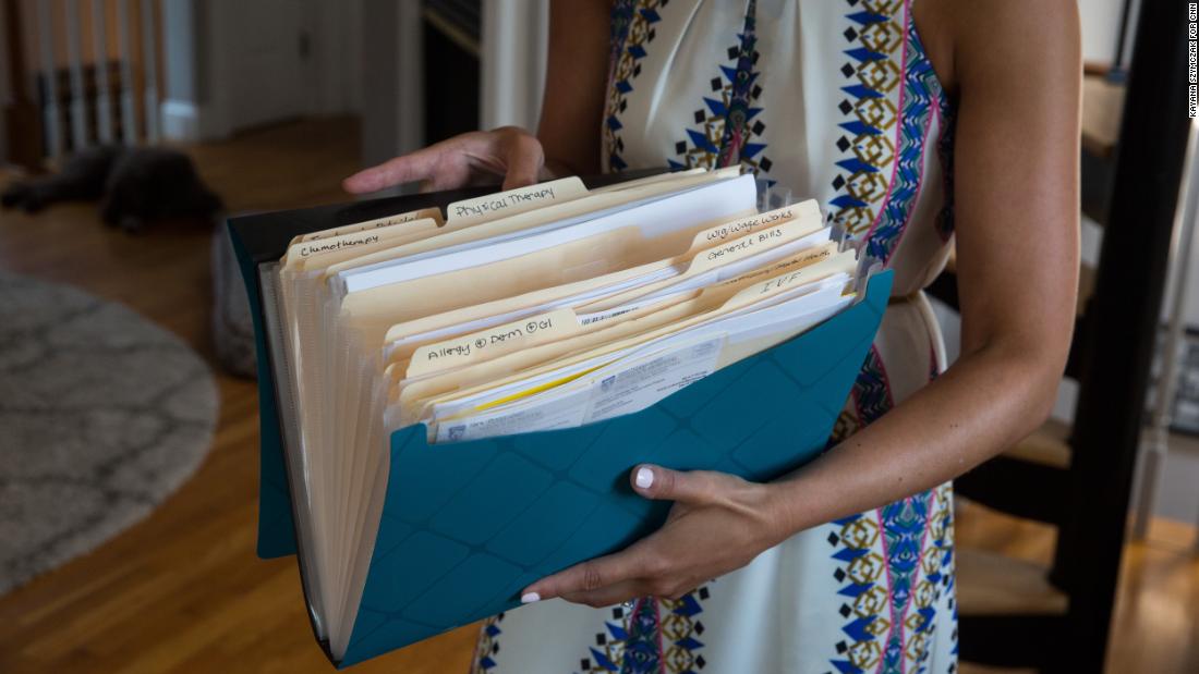 Kate Weissman displays her &quot;cancer folder&quot; containing the paperwork involved in her  treatment and battle with her insurance company. 