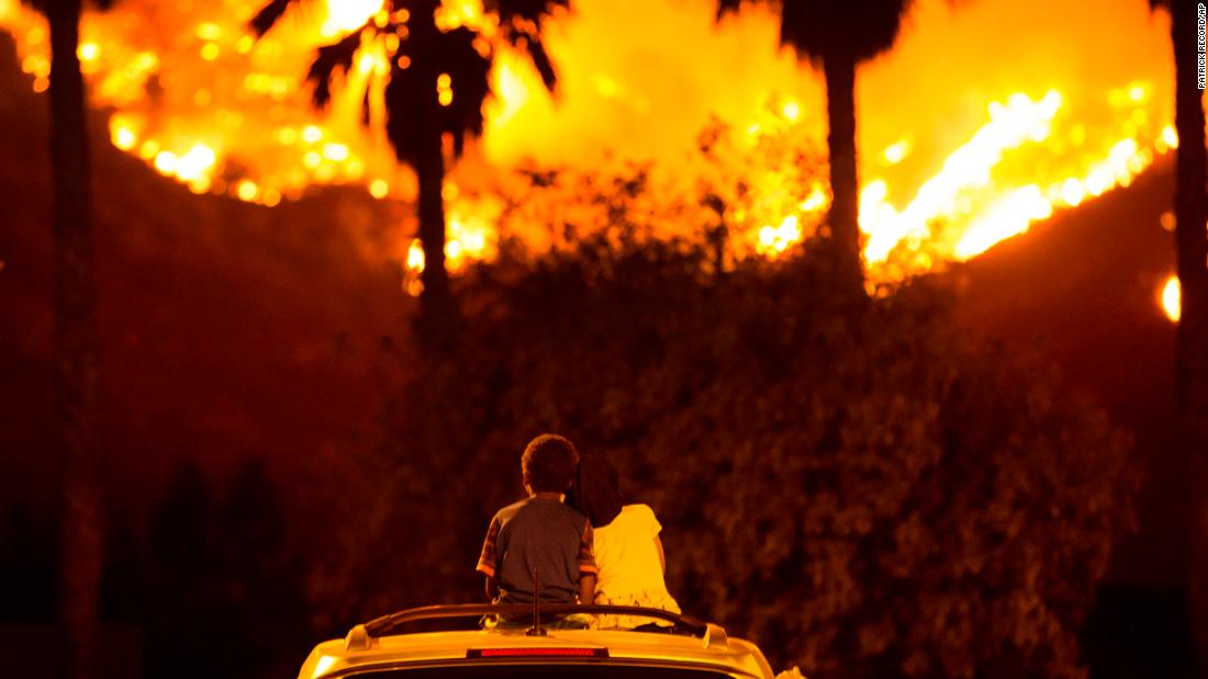 King Bass, 6, and his 5-year-old sister, Princess, watch the Holy Fire burn from the top of their parents&#39; car in Lake Elsinore on Thursday, August 9.