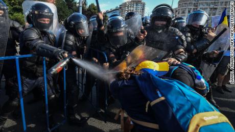 Romanian police scuffle with protesters during an anti-government protest in Bucharest on Friday.
