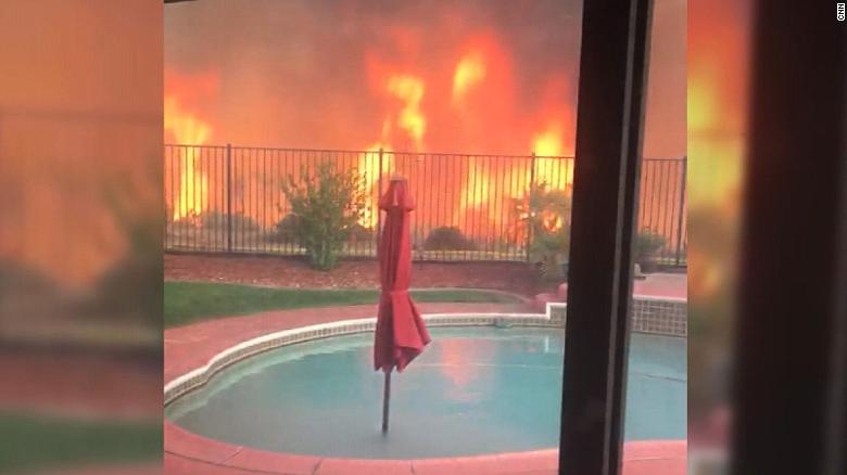 Fire rages feet away from California home