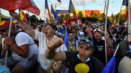Protesters gather outside government offices in Bucharest on Saturday. 