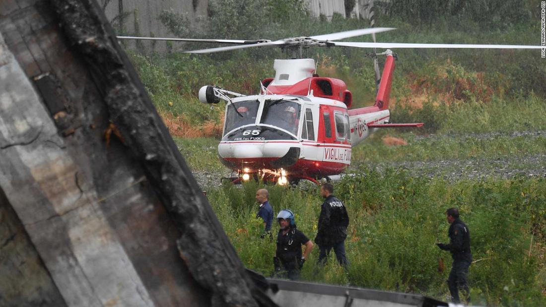 A rescue helicopter lands near the site of the collapse.
