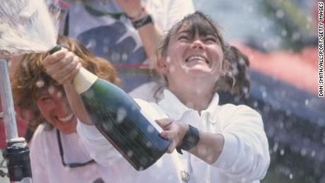 Tracy Edwards, skipper of Maiden, celebrates with champagne after finishing second during the Whitbread round the world yacht race in 1990.