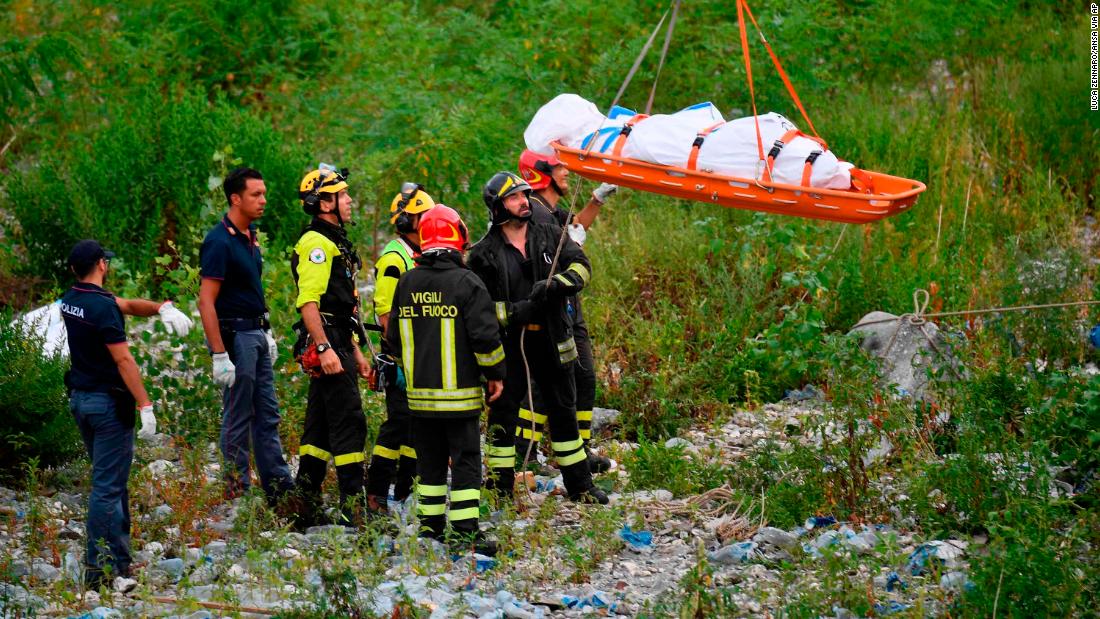 Rescuers on Tuesday recover the body of a victim.