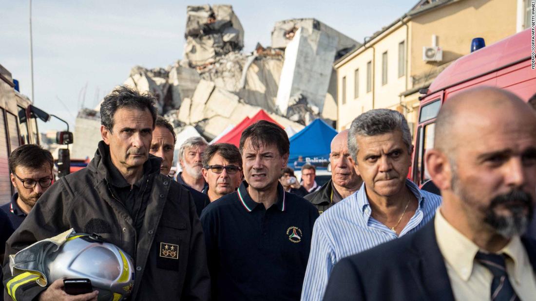 Italian Prime Minister Giuseppe Conte (center) visits the site of the collapse.