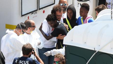 Migrants say goodbye to crew members as they disembark from the Aquarius rescue ship.