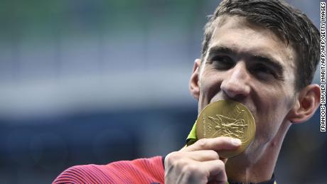 Michael Phelps celebrates with his gold medal during the podium ceremony for the Men&#39;s 4x200m Freestyle Relay Final at the 2016 Olympics.