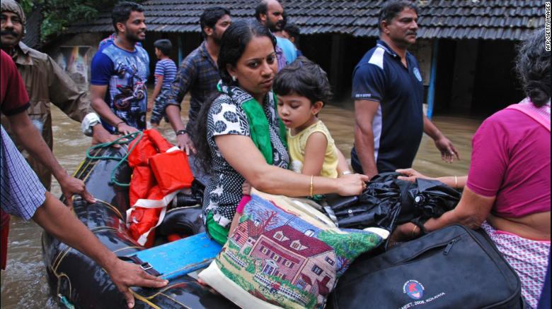 Volunteers and rescue personnel evacuate local residents in a boat in the Indian state of Kerala on August 16.