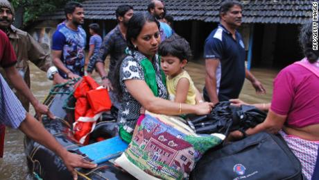 Indian volunteers and rescue personnel evacuate local residents in a boat in a residential area at Kozhikode, in the Indian state of Kerala, on August 16, 2018. - The death toll from floods in India&#39;s tourist hotspot of Kerala increased to 77 on August 16, as torrential rainfall threatened new areas, officials told AFP. (Photo by - / AFP)-/AFP/Getty Images