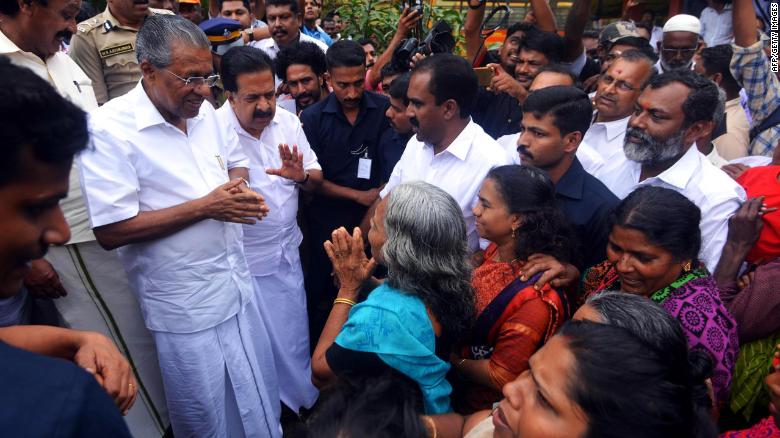 Kerala Chief Minister Pinarayi Vijayan (left) visits a relief camp in the Indian state of Kerala on August 11.