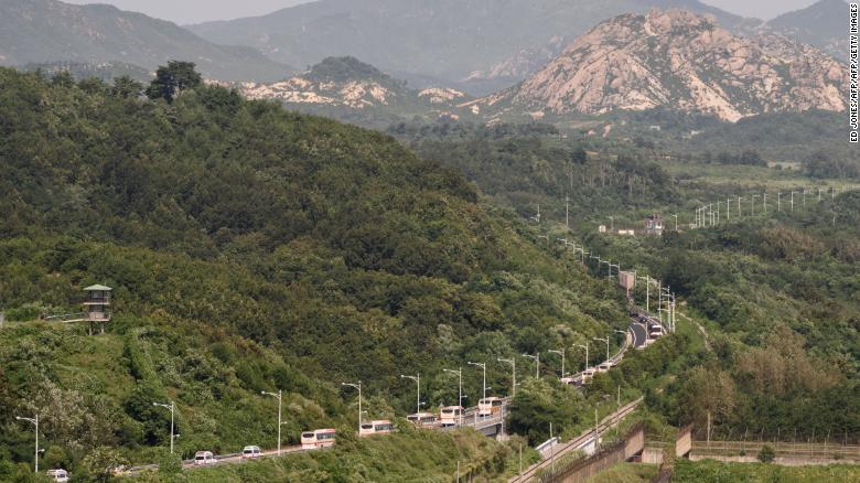 A convoy of buses carrying participants of an inter-Korean family reunion makes its way through the Demilitarized Zone (DMZ) towards North Korea.