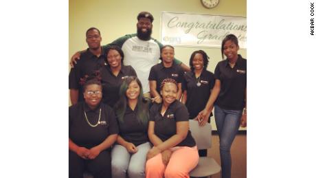 Principal Akbar Cook poses with a few of the graduating students of the West Side High School class of 2018.