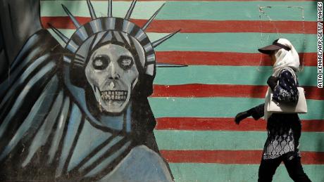 An Iranian woman walks past a mural depicting the Statue of Liberty with a dead face, painted on the wall of the former US embassy in the capital Tehran on August 7, 2018 - US President Donald Trump warned countries against doing business with Iran today as he hailed the &quot;most biting sanctions ever imposed&quot;, triggering a mix of anger, fear and defiance in Tehran. (Photo by ATTA KENARE / AFP)        (Photo credit should read ATTA KENARE/AFP/Getty Images)