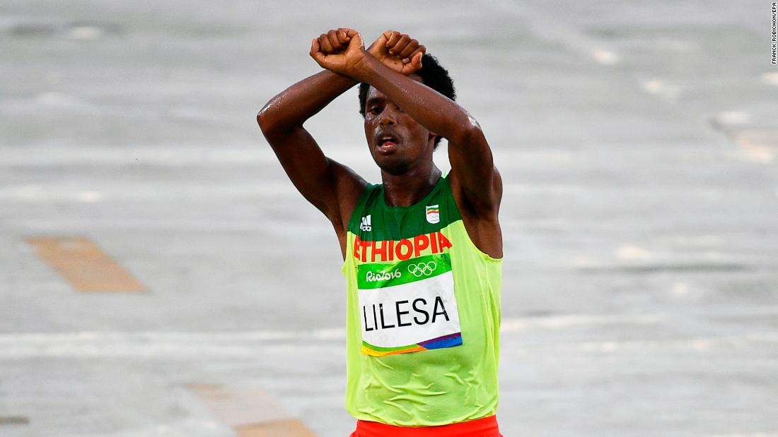 Feyisa Lilesa protests as he takes second place in the men&#39;s marathon race at the Rio 2016 Olympic Games.