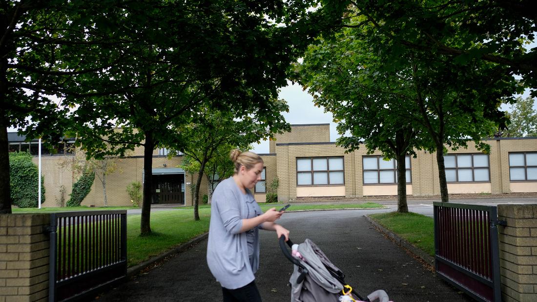 A woman passes one of three Catholic primary schools on Leixlip&#39;s Green Lane.
