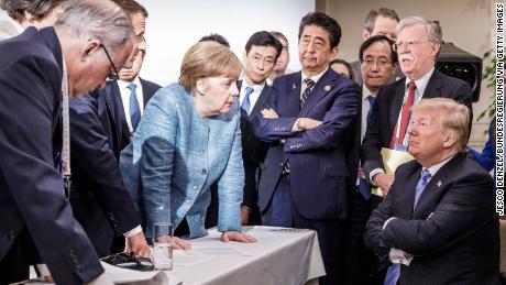 Merkel deliberates with US president Donald Trump on the sidelines of the official agenda on the second day of the G7 summit on June 9, 2018 in Charlevoix, Canada.