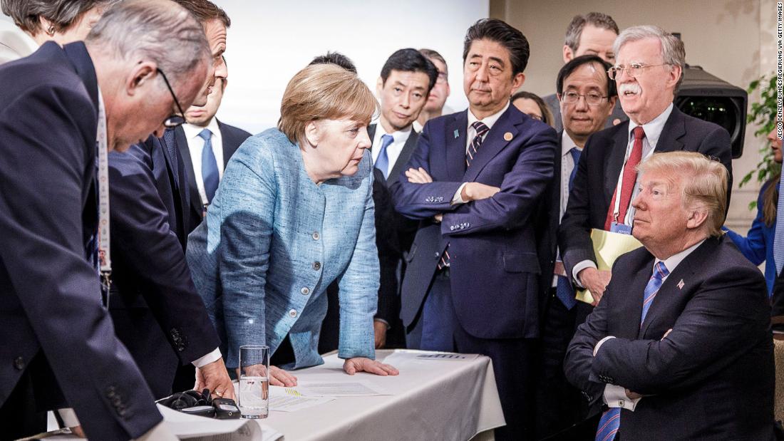 In this photo provided by the German Government Press Office, German Chancellor Angela Merkel talks with a seated Trump as they are surrounded by other leaders at the G7 summit in Charlevoix, Quebec, in June 2018. According to two senior diplomatic sources, &lt;a href=&quot;https://www.cnn.com/2018/06/11/politics/g7-photo/index.html&quot; target=&quot;_blank&quot;&gt;the photo was taken&lt;/a&gt; when there was a difficult conversation taking place regarding the G7&#39;s communique and several issues the United States had leading up to it.