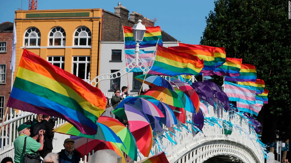 Rainbow flags and blue ribbons are tied to Ha&#39;penny Bridge in Dublin to remember the victims of Catholic Church clerical sex abuse.