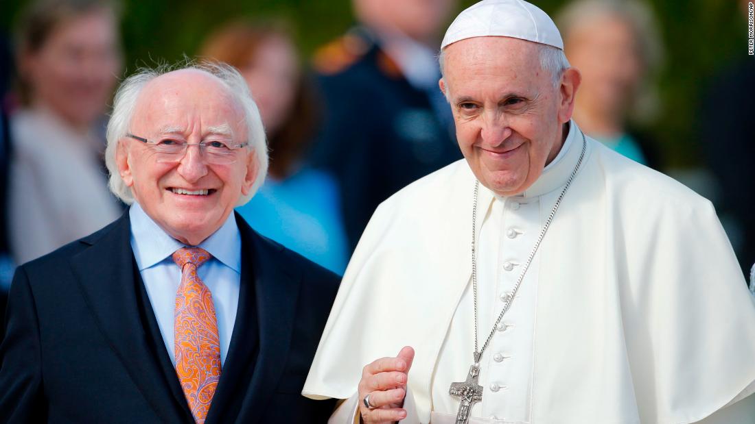 Pope Francis is flanked by Irish President Michael Higgins upon his arrival at the presidential residence in Dublin on Saturday.