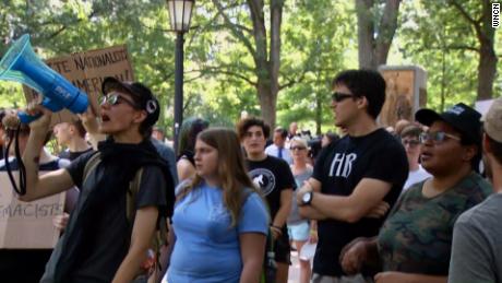 Demostrators gather near the site of the toppled statue on August 25, 2018.