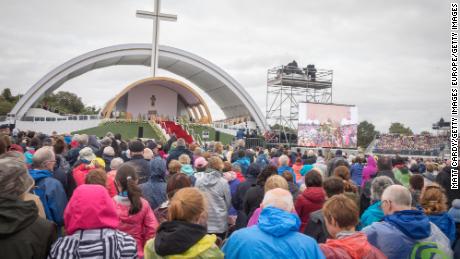 People celebrate Mass in Dublin's Phoenix Park, braving wet and windy weather.