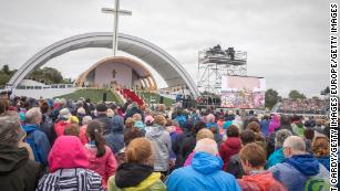 People celebrate Mass in Dublin's Phoenix Park, braving wet and windy weather.