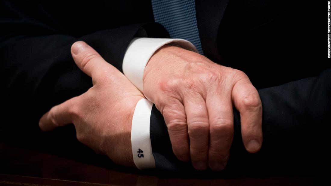 A close-up of Trump&#39;s shirt cuff reads &quot;45&quot; as he speaks during a Cabinet meeting in June 2018.