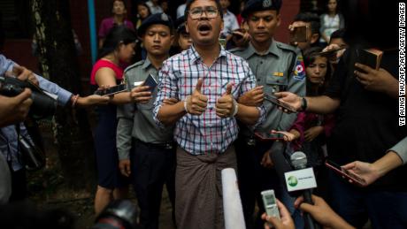 Detained Reuters journalist Wa Lone speaks to journalists after appearing before a court trial in Yangon in August 2018. 