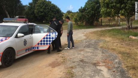 The two men are taken away by local police. 