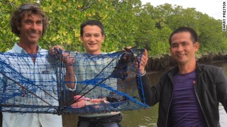 Preston holds up a crab pot with the two men he and Justin Ward picked up on the Daintree River.