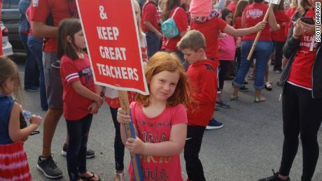 Monroe High School teacher Scott Darrow posted this image of his daughter at a protest earlier this week. The Monroe school year is supposed to start Wednesday.