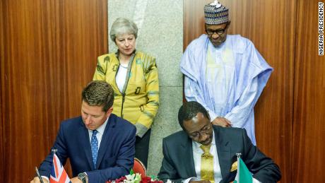 Theresa May and Muhammadu Buhari witness as Nigeria National Security Adviser, Babagana Monguno and British Deputy National Security Adviser, Christian Turner sign the Bilateral Agreement on Defence and Security Partnership in Abuja on August 29, 2018. 