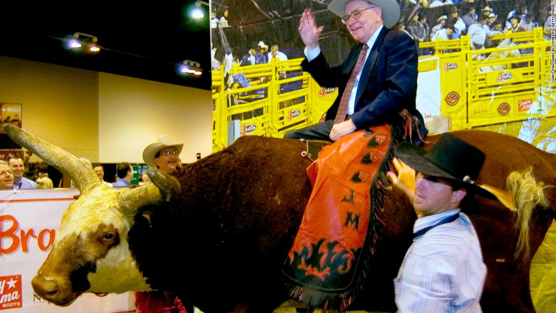 Buffett sits atop a fake bull at the Berkshire Hathaway annual meeting in 2006.