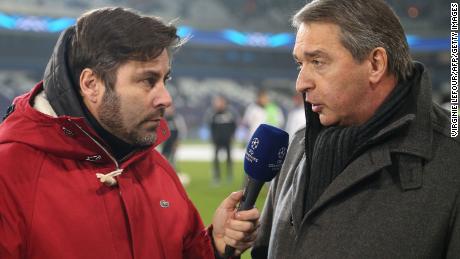 Belgian sport journalist and presentator Stephane Pauwels (L) speaks with Herman Van Holsbeeck ahead of Champions League group C the football match on November 27, 2013 in Brussels. 