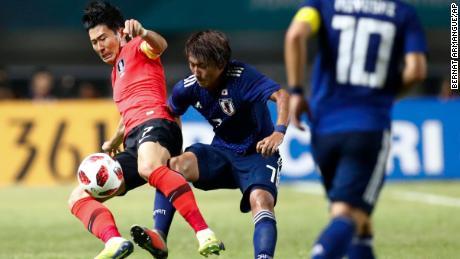South Korea&#39;s Son Heung-min, left, duels for the ball against Japan&#39;s Teruki Hara during Saturday&#39;s match.