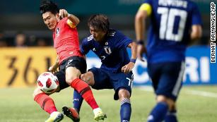 South Korea's Son Heung-min, left, duels for the ball against Japan's Teruki Hara during Saturday's match.