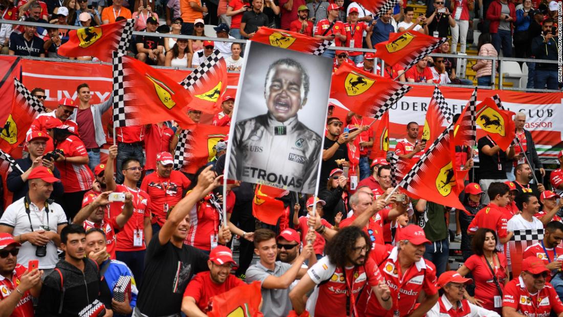 Ferrari&#39;s sea of fans -- the &#39;Tifosi&#39; -- hold up a flag making fun of Lewis Hamilton, but he has the last laugh, winning the Italian Grand Prix for the fifth time
