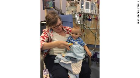 Grandmother Gail Brown holds Juan Pedro at the hospital.