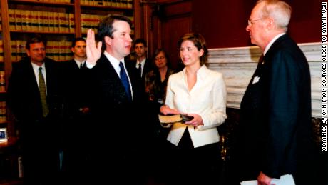 Judge Brett Kavanaugh being sworn into the DC Circuit by Supreme Court Justice Anthony Kennedy in Kennedy's chambers in May 2006, with Chief Justice John Roberts in the background.