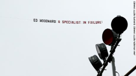 A banner reading 'Ed Woodward a specialist in failure!' is flown over Turf Moor