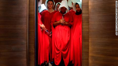 Women dressed as characters from &quot;The Handmaid&#39;s Tale&quot; at the Hart Senate Office Building, protesting Supreme Court nominee Brett Kavanaugh in 2018. 